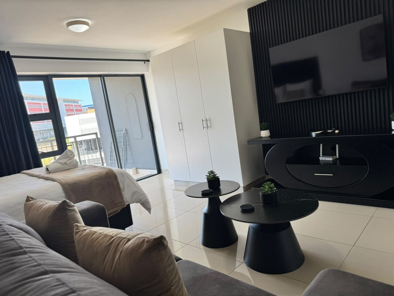 Living area with television and black slat wall